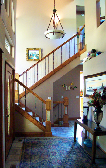 This Custom Home's Main Entrance has Rich Woodwork and Space